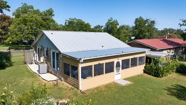 a aerial view of a house with yard and lake view