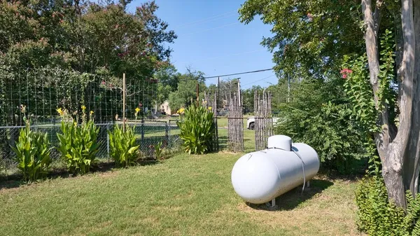 a view of a chair and table in backyard