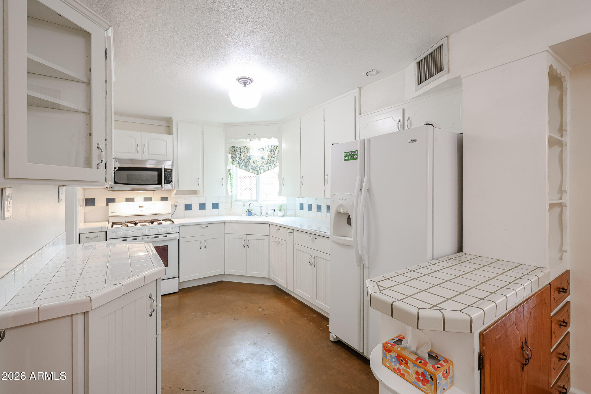 3108 North 21st Place Phoenix, AZ 85016 - Photo 15 of 56 a kitchen with a sink stove and refrigerator