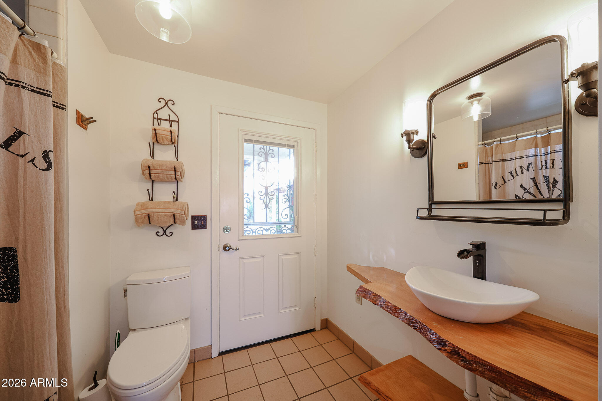 3108 North 21st Place Phoenix, AZ 85016 - Photo 24 of 56 a bathroom with a toilet a sink and mirror
