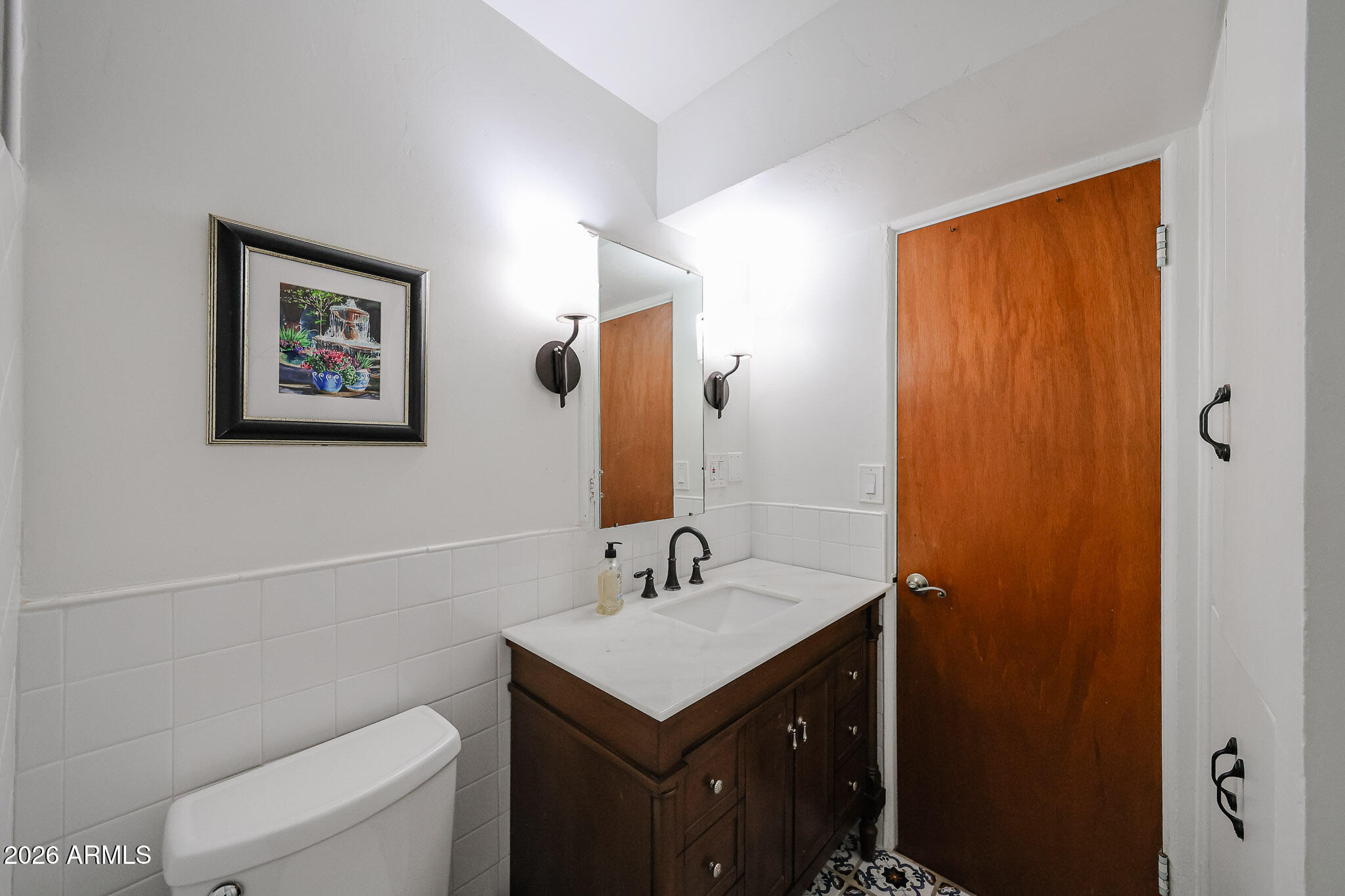 3108 North 21st Place Phoenix, AZ 85016 - Photo 32 of 56 a bathroom with a granite countertop sink toilet and a mirror