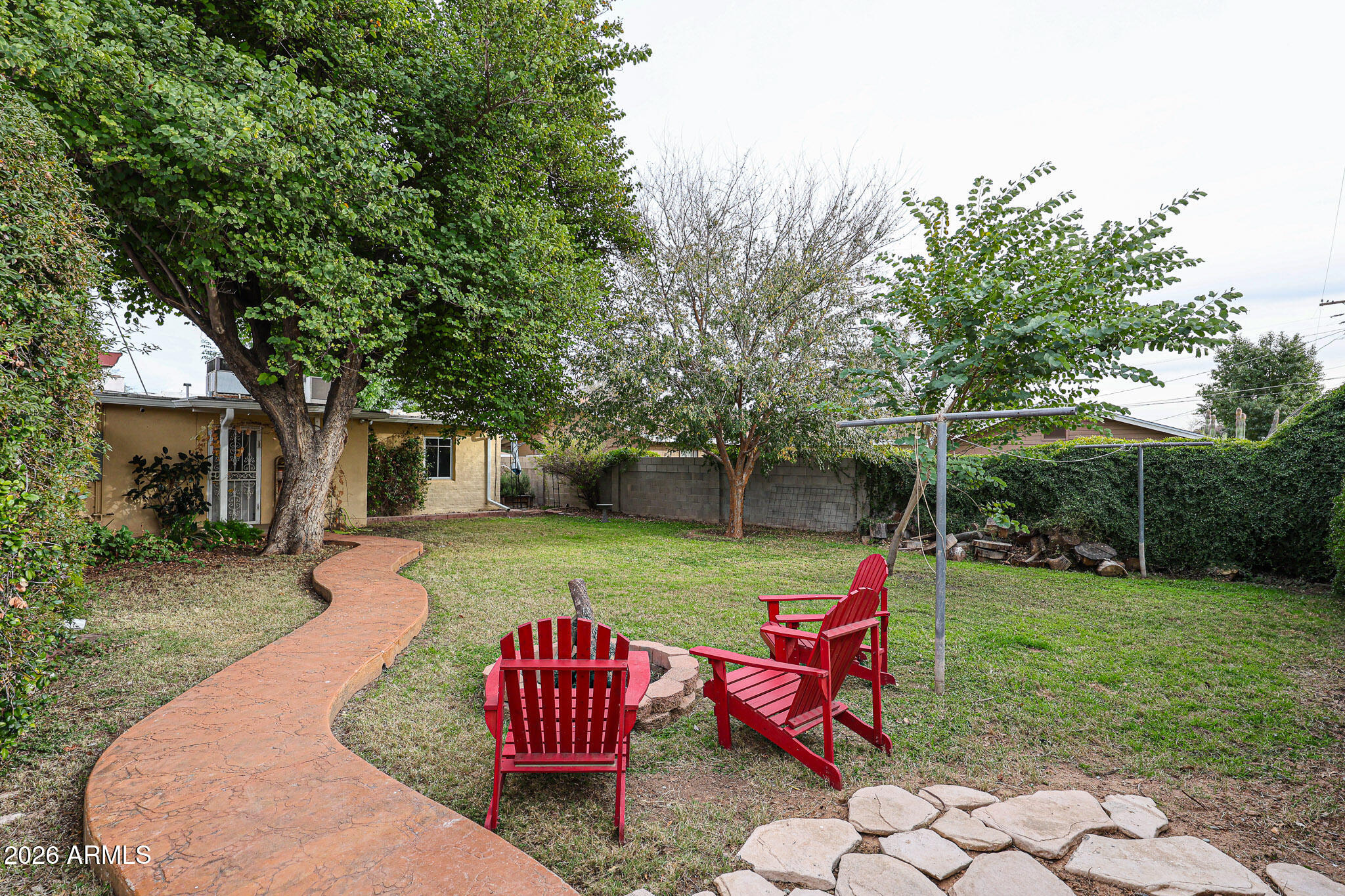 3108 North 21st Place Phoenix, AZ 85016 - Photo 43 of 56 a view of a backyard with table and chairs under an umbrella