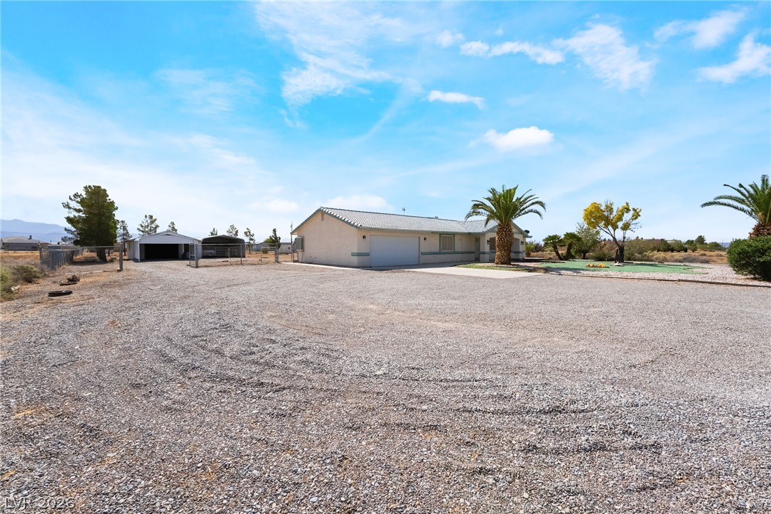 3631 South Blagg Road Pahrump, NV 89048 - Photo 47 of 47 A desert oasis with expansive gravel parking, a spacious garage, and a lush putting green for outdoor enjoyment.