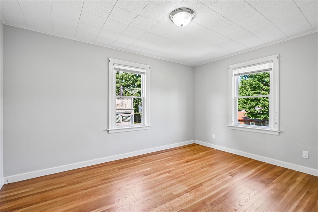 42 East Main Street Gloucester, MA 01930 - Photo 4 of 25 an empty room with wooden floor and windows