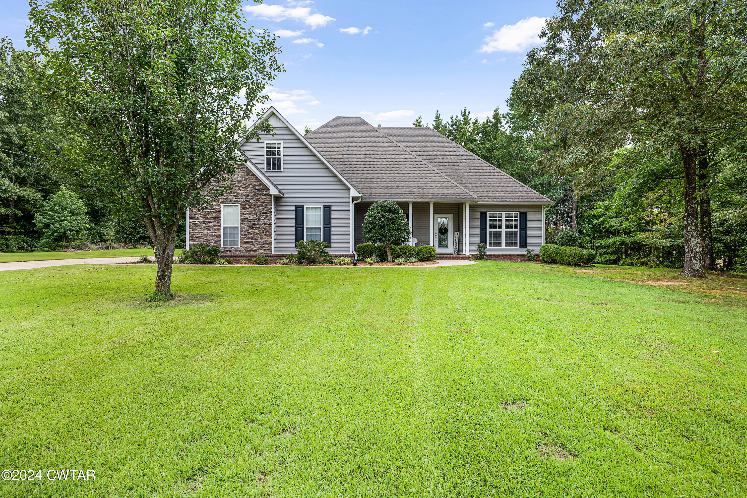 245 Station Road Beech Bluff, TN 38313 - Photo 1 of 23 a front view of a house with a yard and trees
