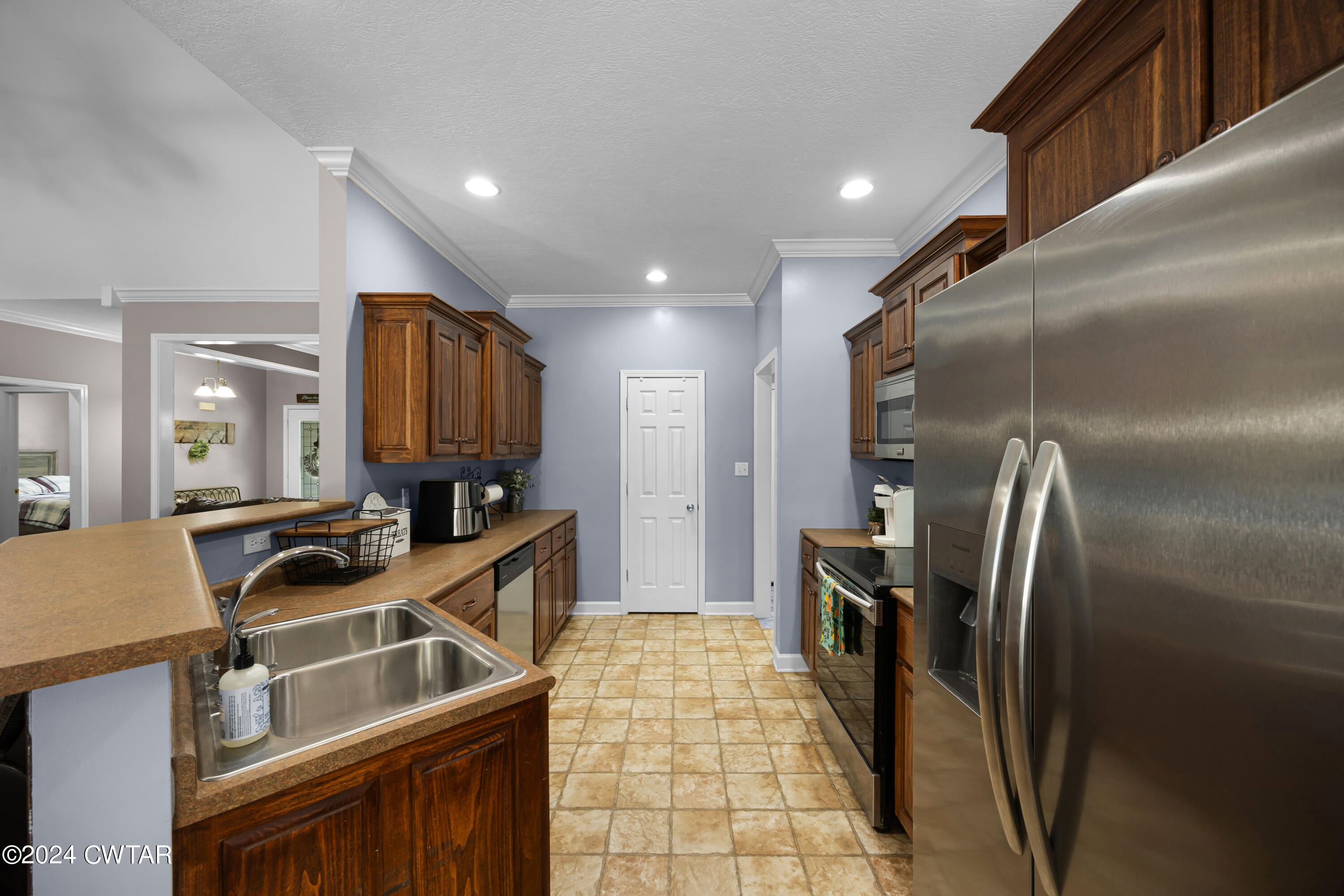 245 Station Road Beech Bluff, TN 38313 - Photo 12 of 23 a kitchen with granite countertop a refrigerator and a sink