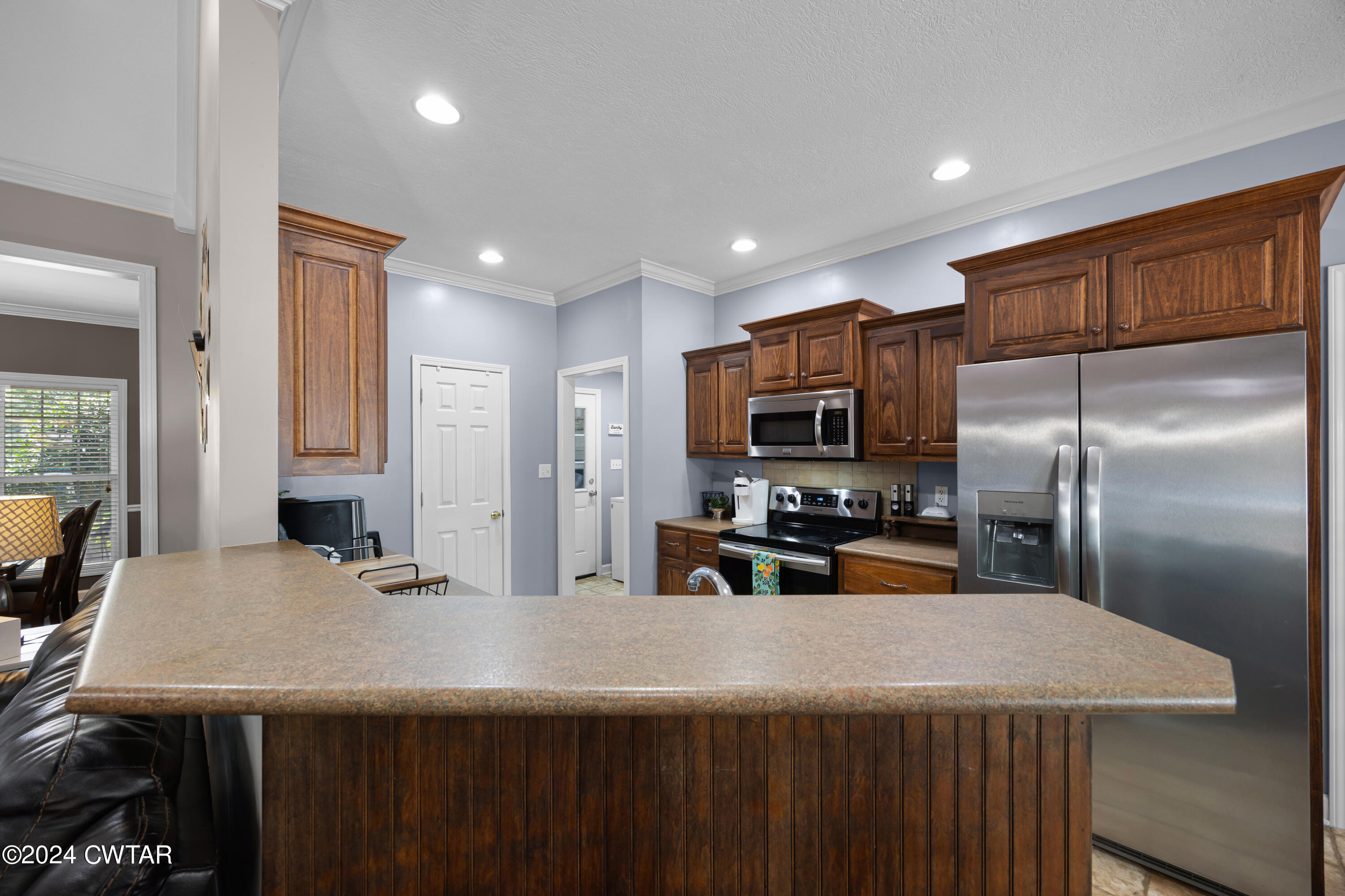 245 Station Road Beech Bluff, TN 38313 - Photo 13 of 23 a kitchen with kitchen island a sink stainless steel appliances and window