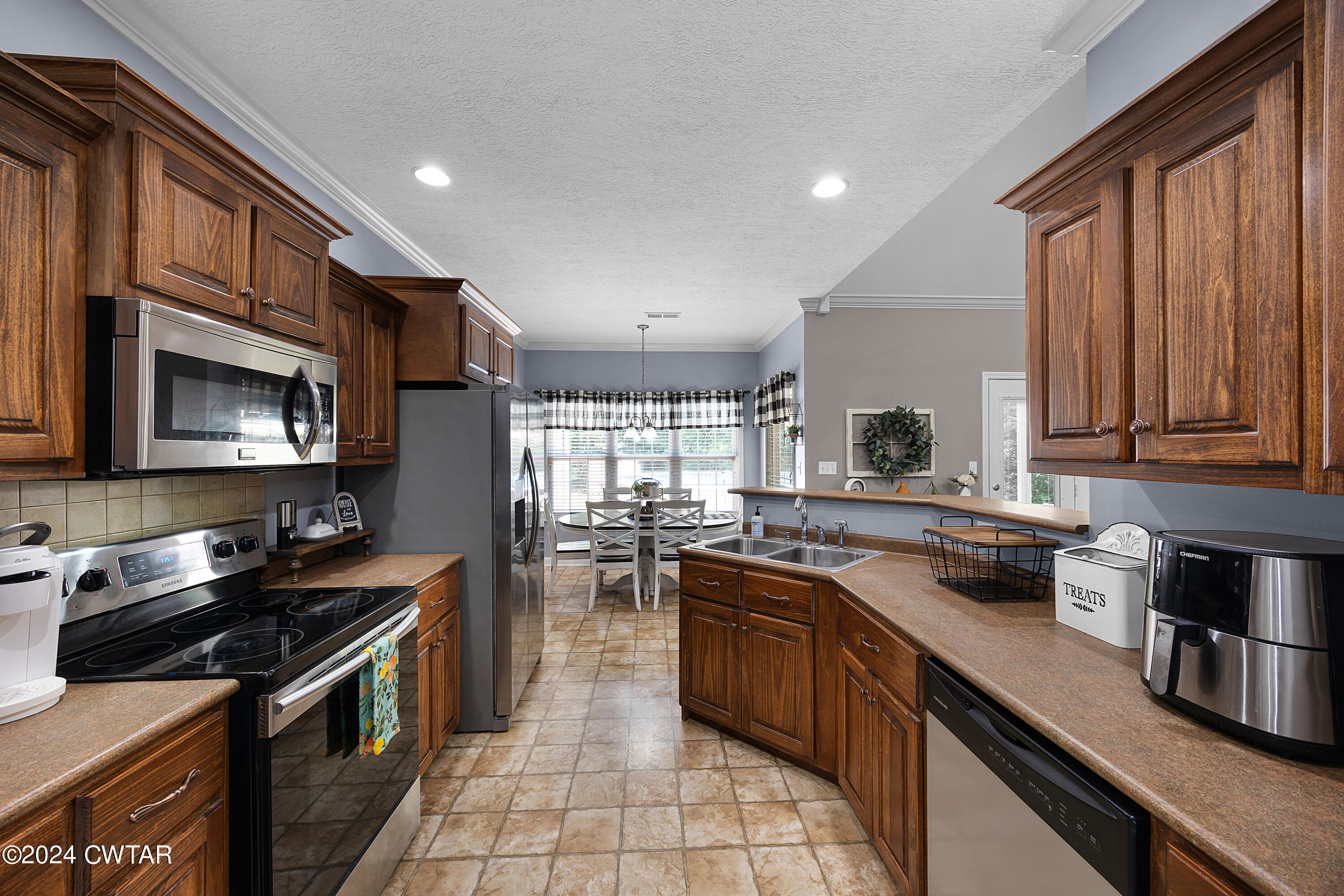 245 Station Road Beech Bluff, TN 38313 - Photo 14 of 23 a kitchen with stainless steel appliances a stove sink microwave and cabinets