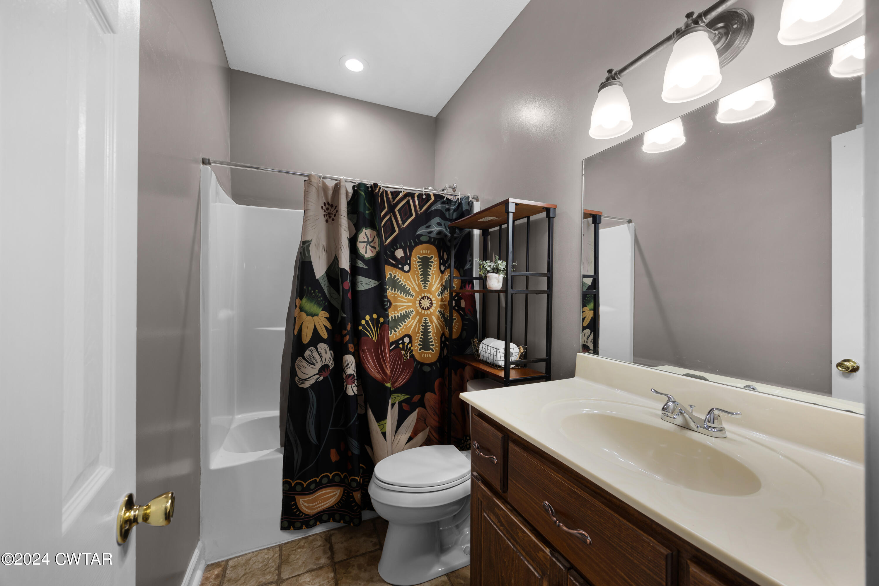 245 Station Road Beech Bluff, TN 38313 - Photo 18 of 23 a bathroom with a sink a toilet a mirror and shower curtain