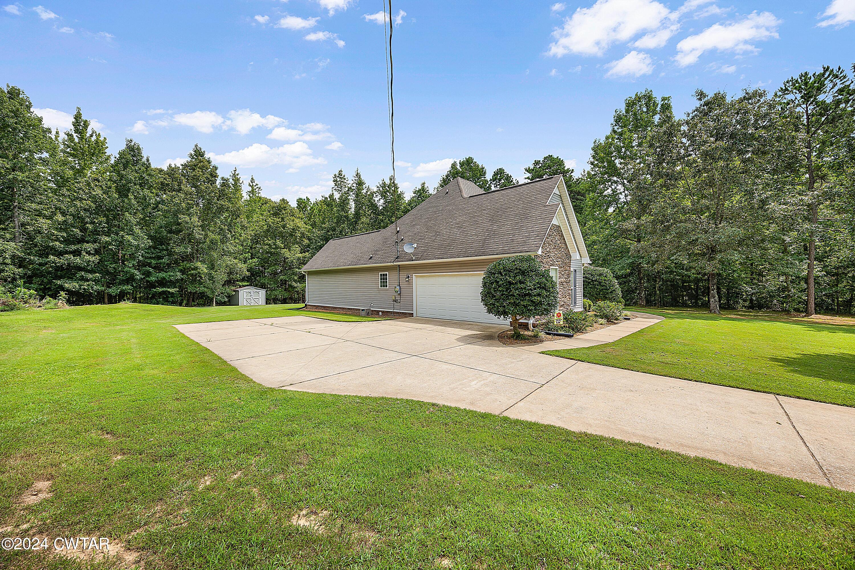 245 Station Road Beech Bluff, TN 38313 - Photo 2 of 23 a house view with a garden space
