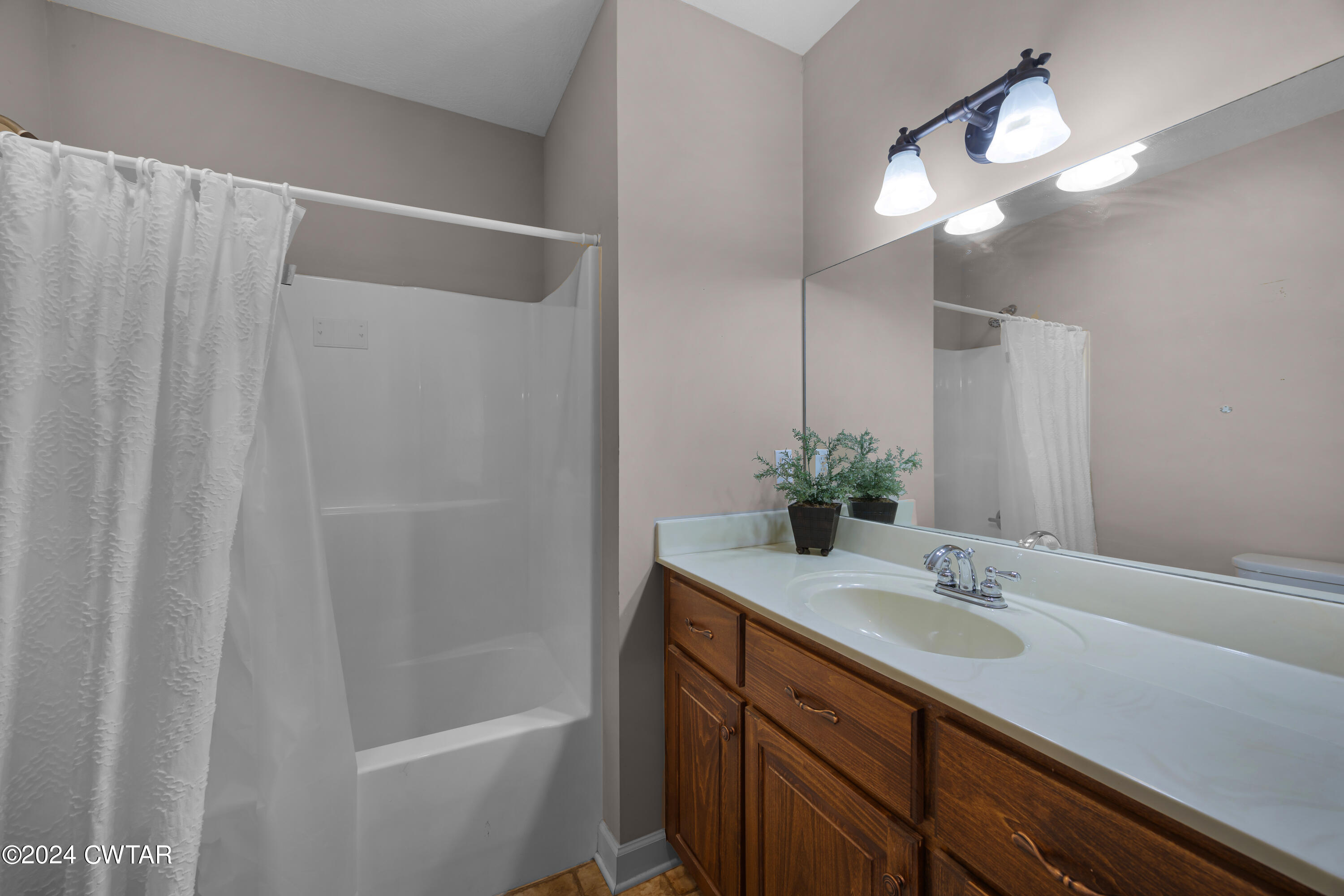 245 Station Road Beech Bluff, TN 38313 - Photo 21 of 23 a bathroom with a sink a light fixture and a mirror
