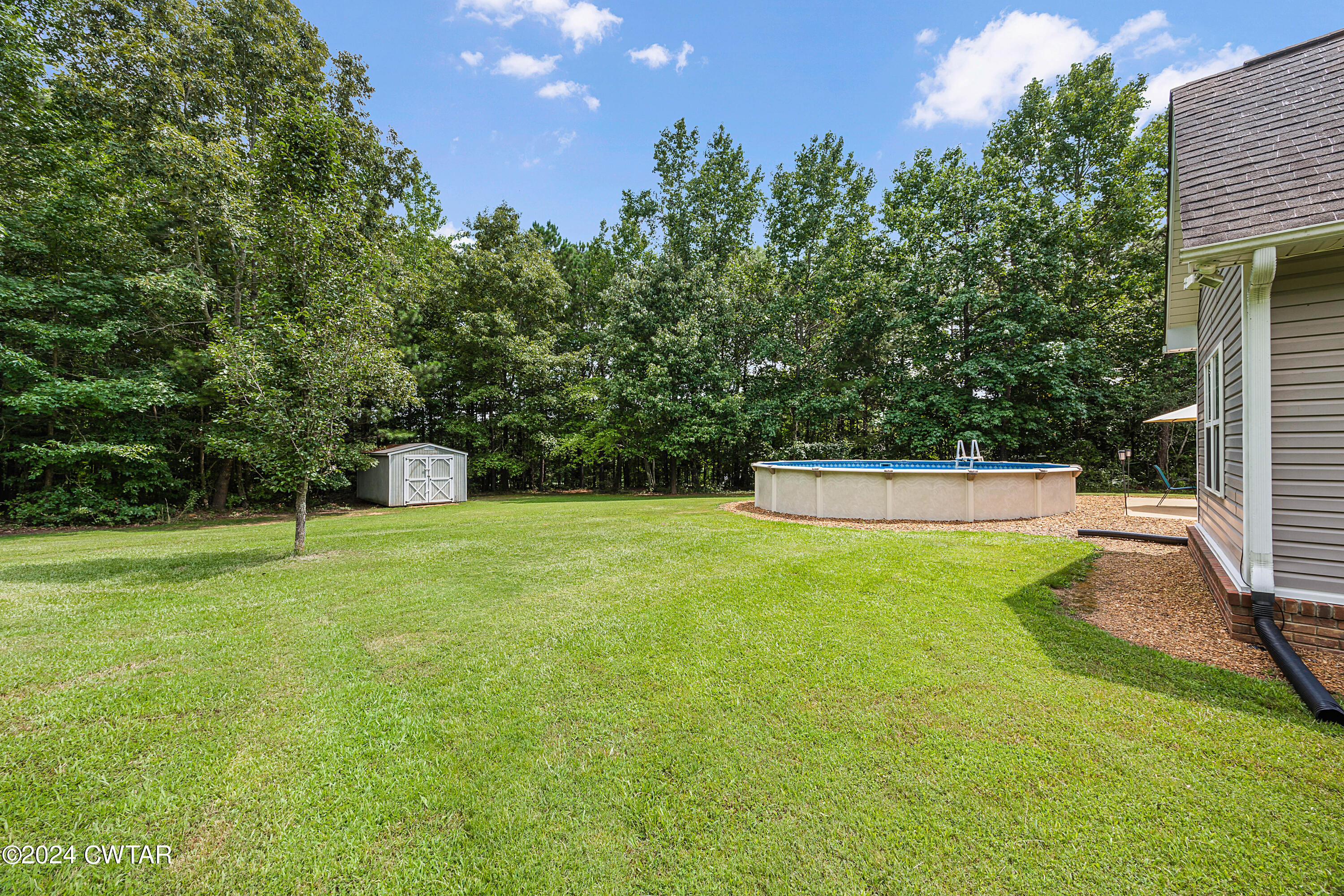 245 Station Road Beech Bluff, TN 38313 - Photo 23 of 23 a view of a backyard with a trampoline