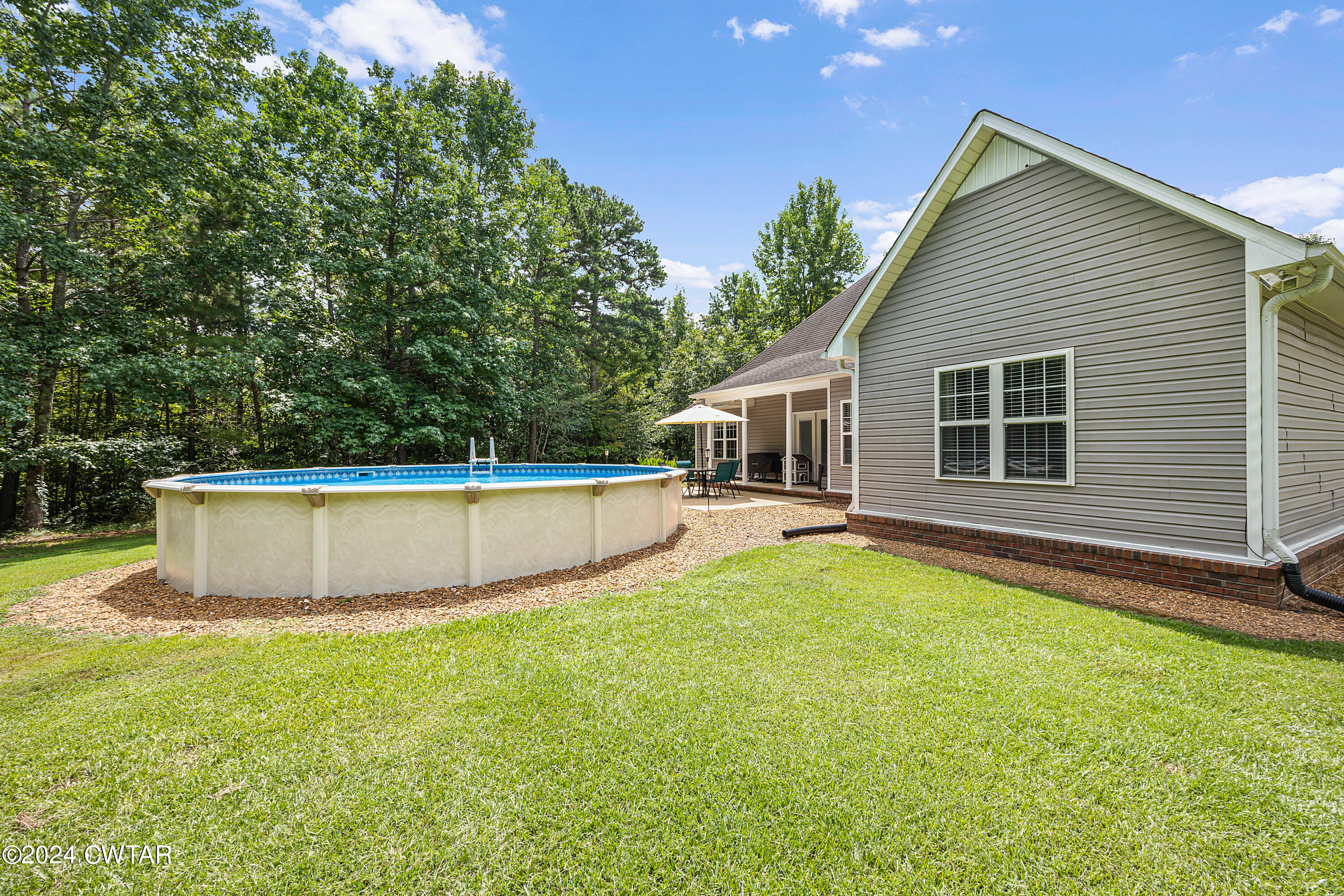 245 Station Road Beech Bluff, TN 38313 - Photo 3 of 23 a view of a house with a swimming pool and sitting area