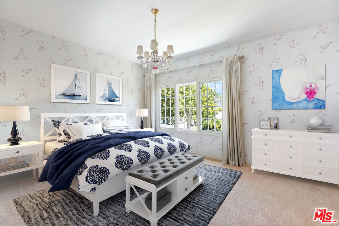 218 Foothill Road Beverly Hills, CA 90210 - Photo 12 of 16 a bedroom with a bed and a chandelier