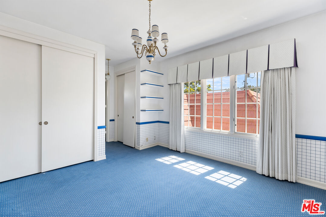 218 Foothill Road Beverly Hills, CA 90210 - Photo 13 of 16 a view of livingroom with furniture cabinet and window