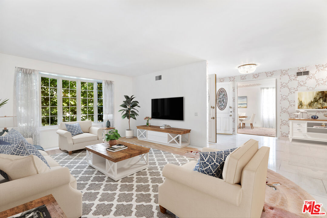 218 Foothill Road Beverly Hills, CA 90210 - Photo 3 of 16 a living room with furniture and a flat screen tv