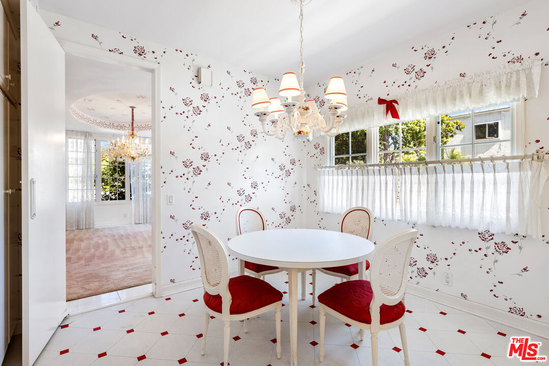 218 Foothill Road Beverly Hills, CA 90210 - Photo 6 of 16 a view of a bedroom with a table and chairs