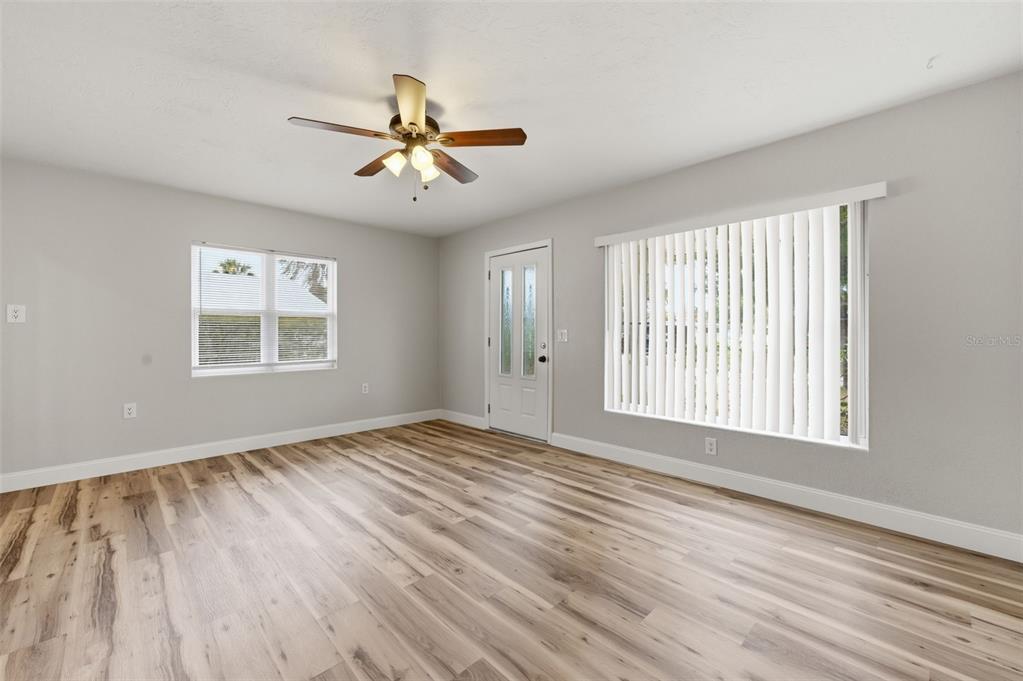 5340 Dartmouth Road New Port Richey, FL 34652 - Photo 12 of 41 a view of an empty room with a window and wooden floor