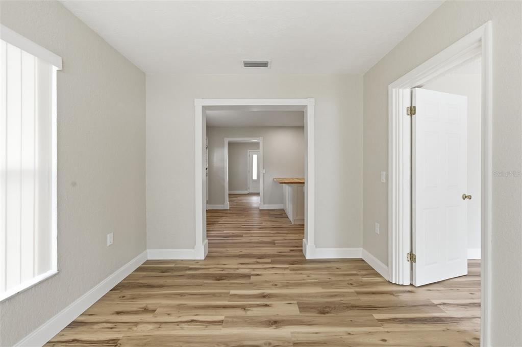 5340 Dartmouth Road New Port Richey, FL 34652 - Photo 20 of 41 a view of a hallway with wooden floor and a bathroom