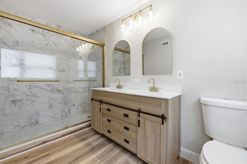 5340 Dartmouth Road New Port Richey, FL 34652 - Photo 8 of 41 a bathroom with a double vanity sink mirror and toilet