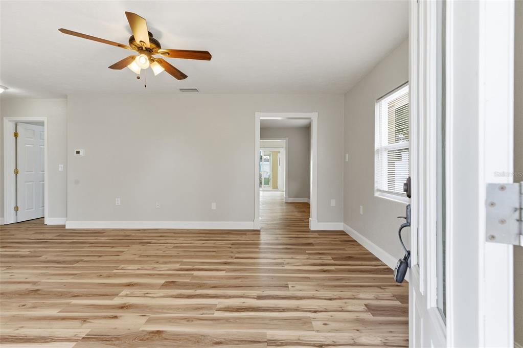 5340 Dartmouth Road New Port Richey, FL 34652 - Photo 9 of 41 a view of a livingroom with wooden floor and a ceiling fan