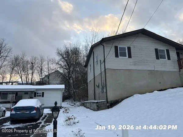 a backyard of a house with fire pit and chairs