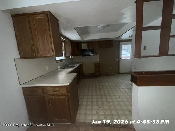 a kitchen with a sink and cabinets