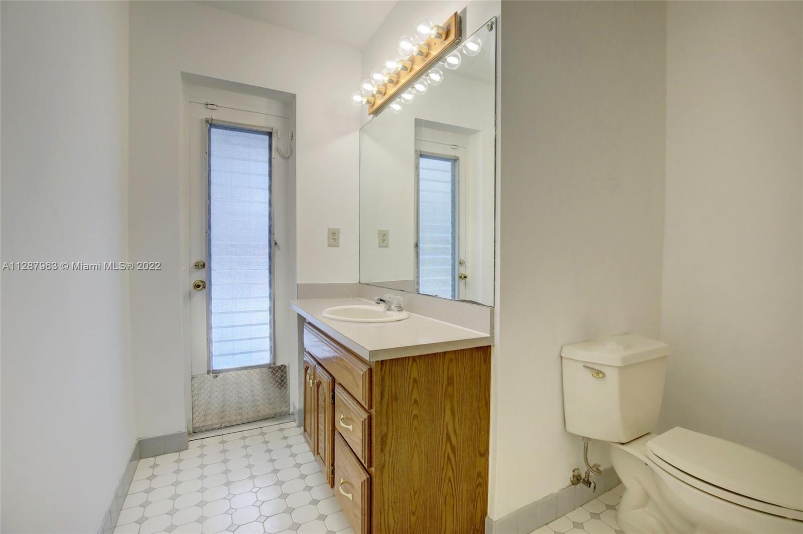 8751 Ridgeland Drive Cutler Bay, FL 33157 - Photo 18 of 26 a bathroom with a sink a toilet and shower