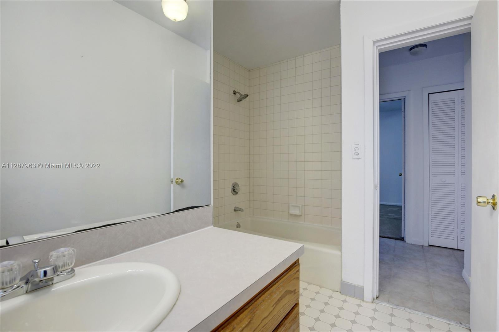 8751 Ridgeland Drive Cutler Bay, FL 33157 - Photo 19 of 26 a bathroom with a sink and a mirror
