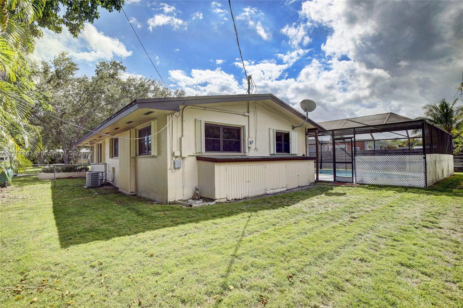 8751 Ridgeland Drive Cutler Bay, FL 33157 - Photo 20 of 26 a front view of a house with a yard and garage
