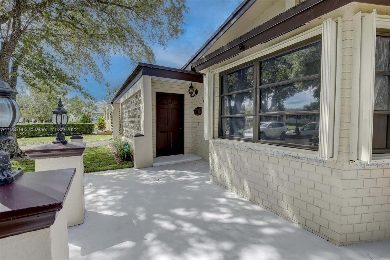8751 Ridgeland Drive Cutler Bay, FL 33157 - Photo 3 of 26 a view of a house with a yard and potted plants