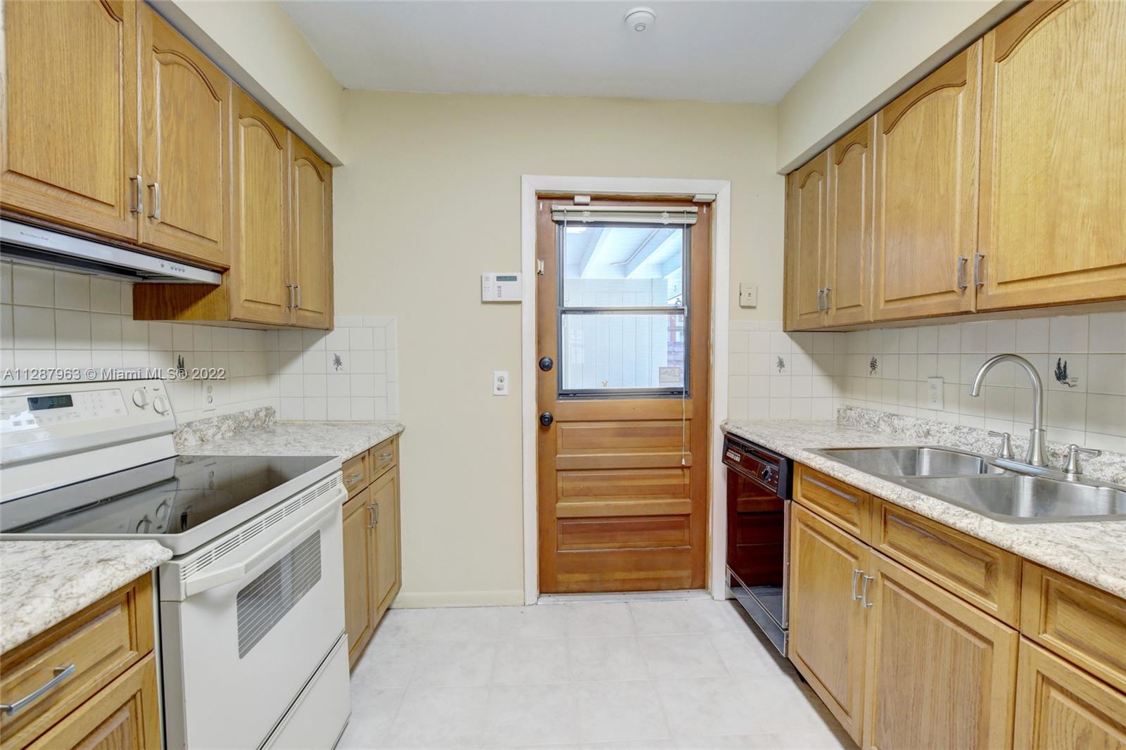 8751 Ridgeland Drive Cutler Bay, FL 33157 - Photo 6 of 26 a kitchen with stainless steel appliances granite countertop a sink and a stove top oven