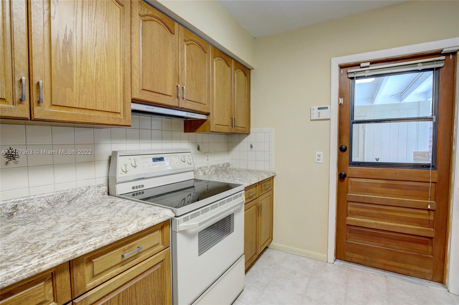 8751 Ridgeland Drive Cutler Bay, FL 33157 - Photo 7 of 26 a kitchen with granite countertop white cabinets and white appliances