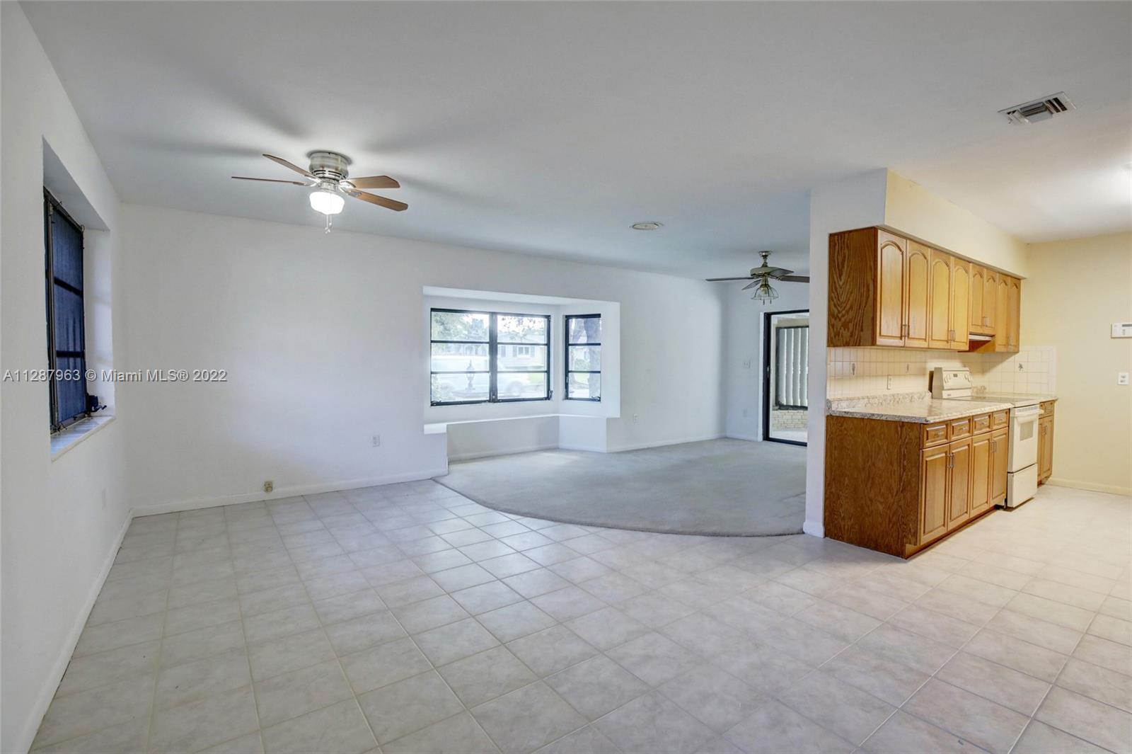 8751 Ridgeland Drive Cutler Bay, FL 33157 - Photo 9 of 26 a living room with furniture and a flat screen tv