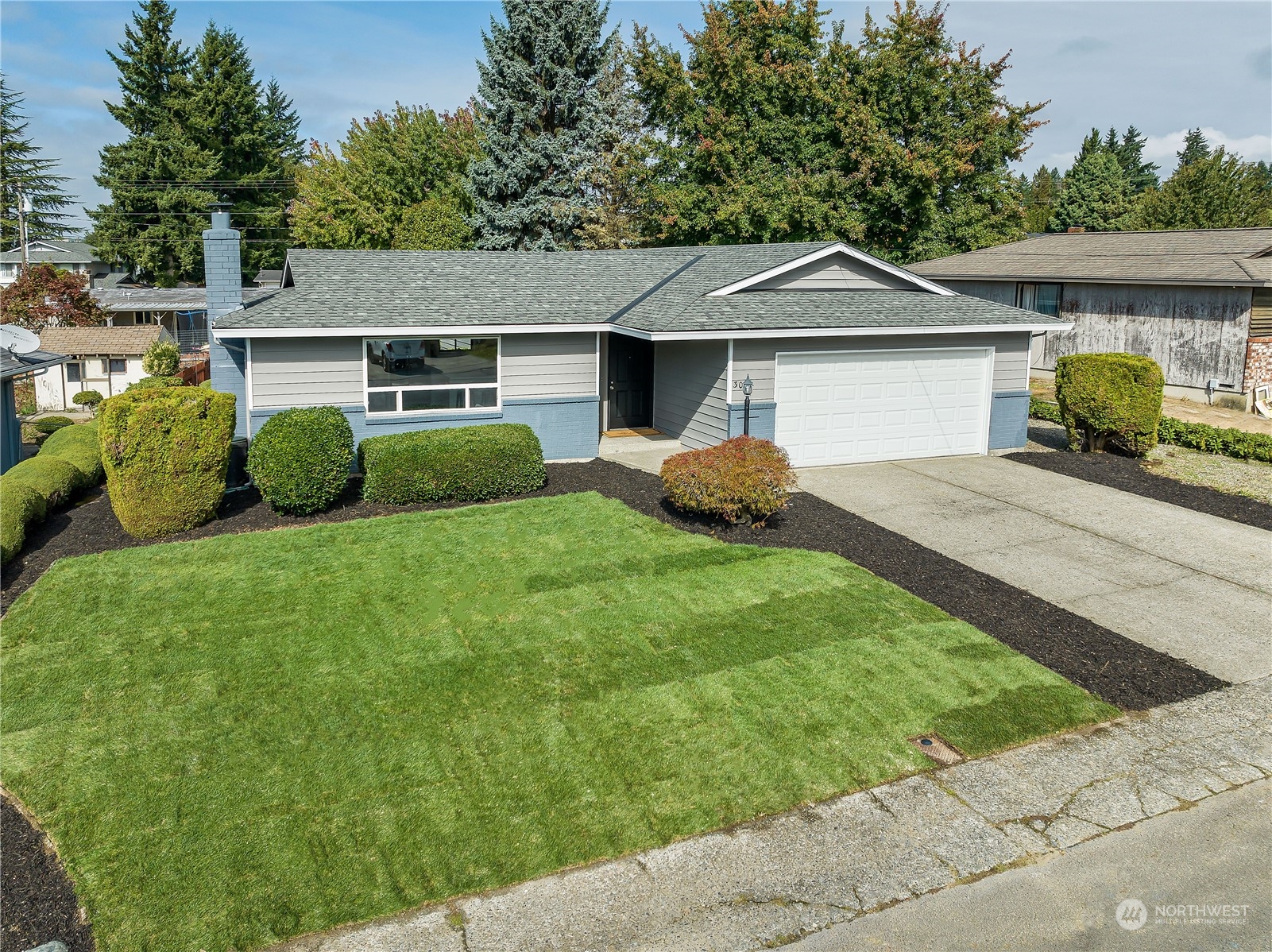 3024 Northeast 7th Street Renton, WA 98056 - Photo 2 of 23 a front view of a house with garden