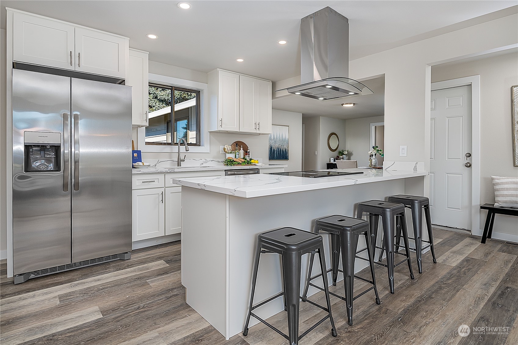 3024 Northeast 7th Street Renton, WA 98056 - Photo 6 of 23 a kitchen with stainless steel appliances granite countertop a sink a stove a refrigerator and island with wooden floor