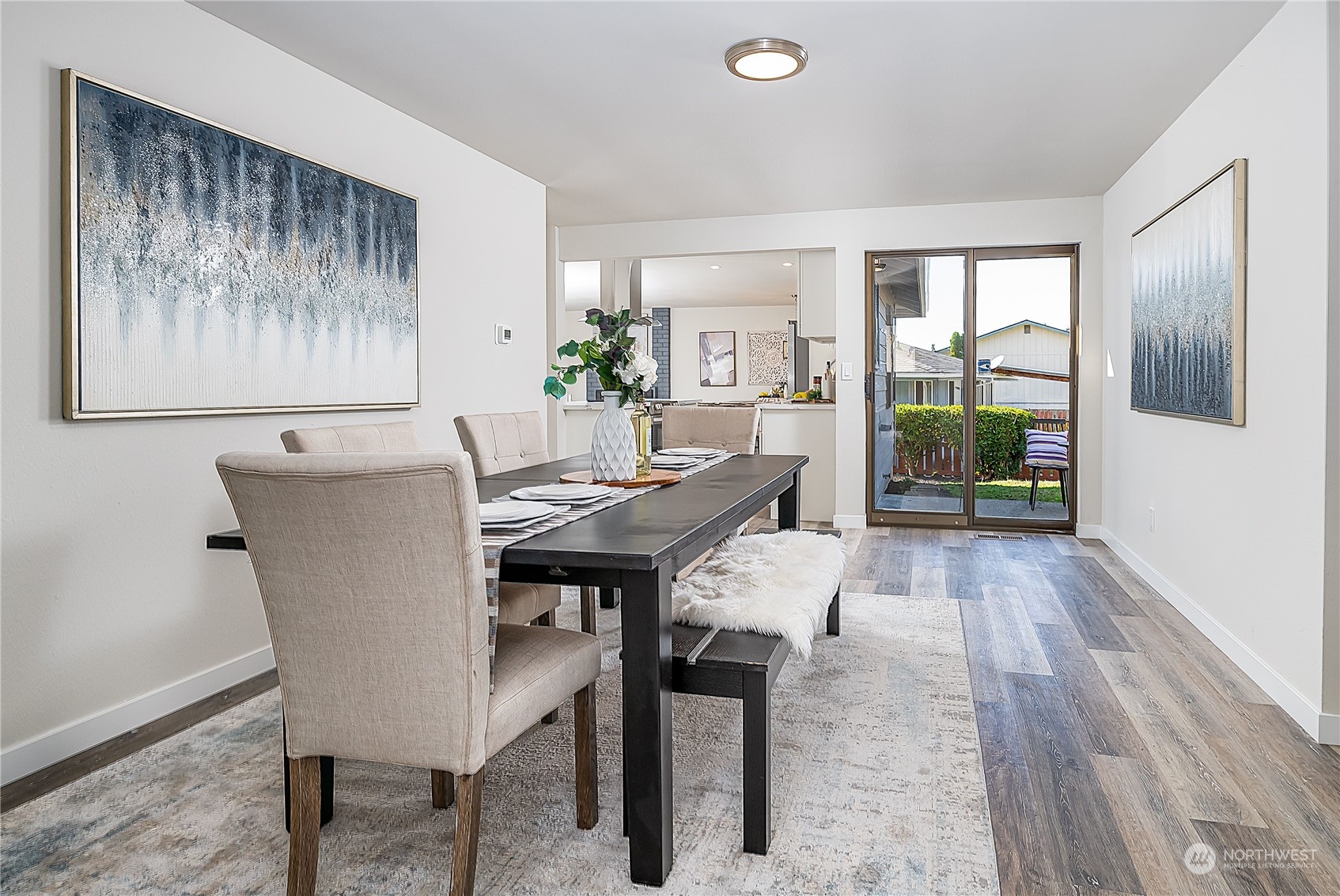 3024 Northeast 7th Street Renton, WA 98056 - Photo 10 of 23 a view of a dining room with furniture window and wooden floor