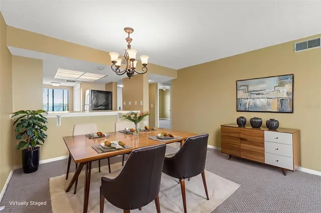 a dining room with furniture a livingroom and chandelier