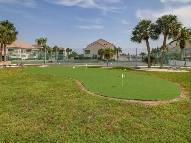 a living room with furniture and view of kitchen