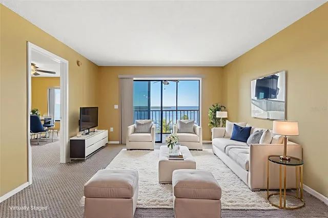 a living room with furniture or couch and a large window