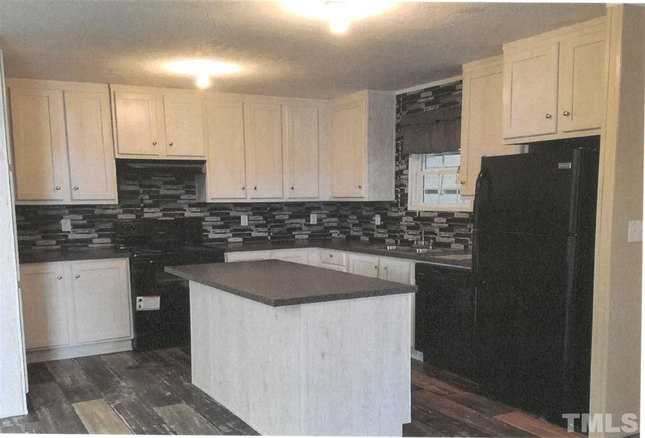 3013 Edgemont Road Wendell, NC 27591 - Photo 3 of 3 a kitchen with granite countertop white cabinets and stainless steel appliances