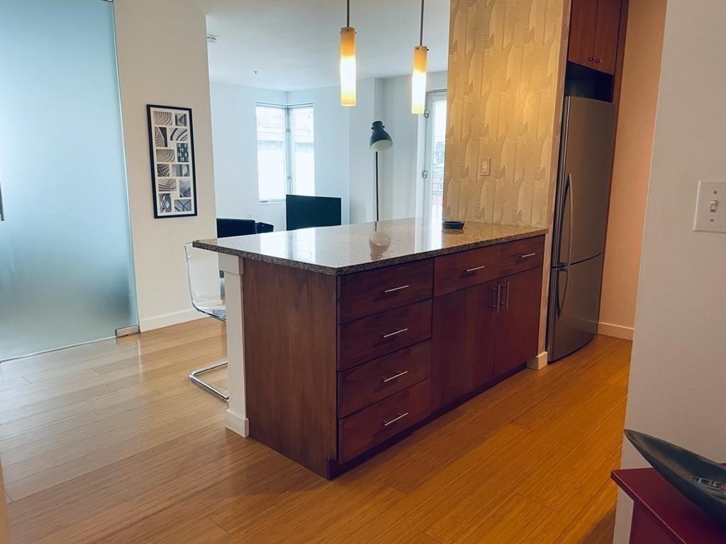 16 Miner Street, Unit 510 Boston, MA 02215 - Photo 20 of 26 a spacious bathroom with a granite countertop sink a mirror and a shower