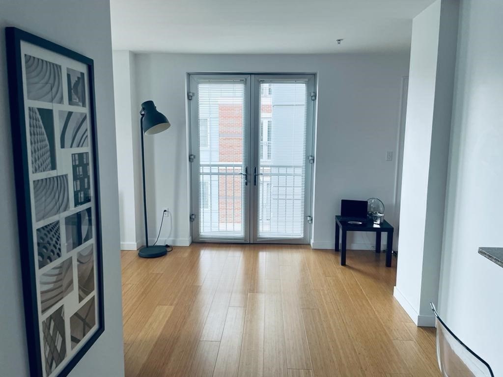 16 Miner Street, Unit 510 Boston, MA 02215 - Photo 22 of 26 wooden floor in an empty room with a window