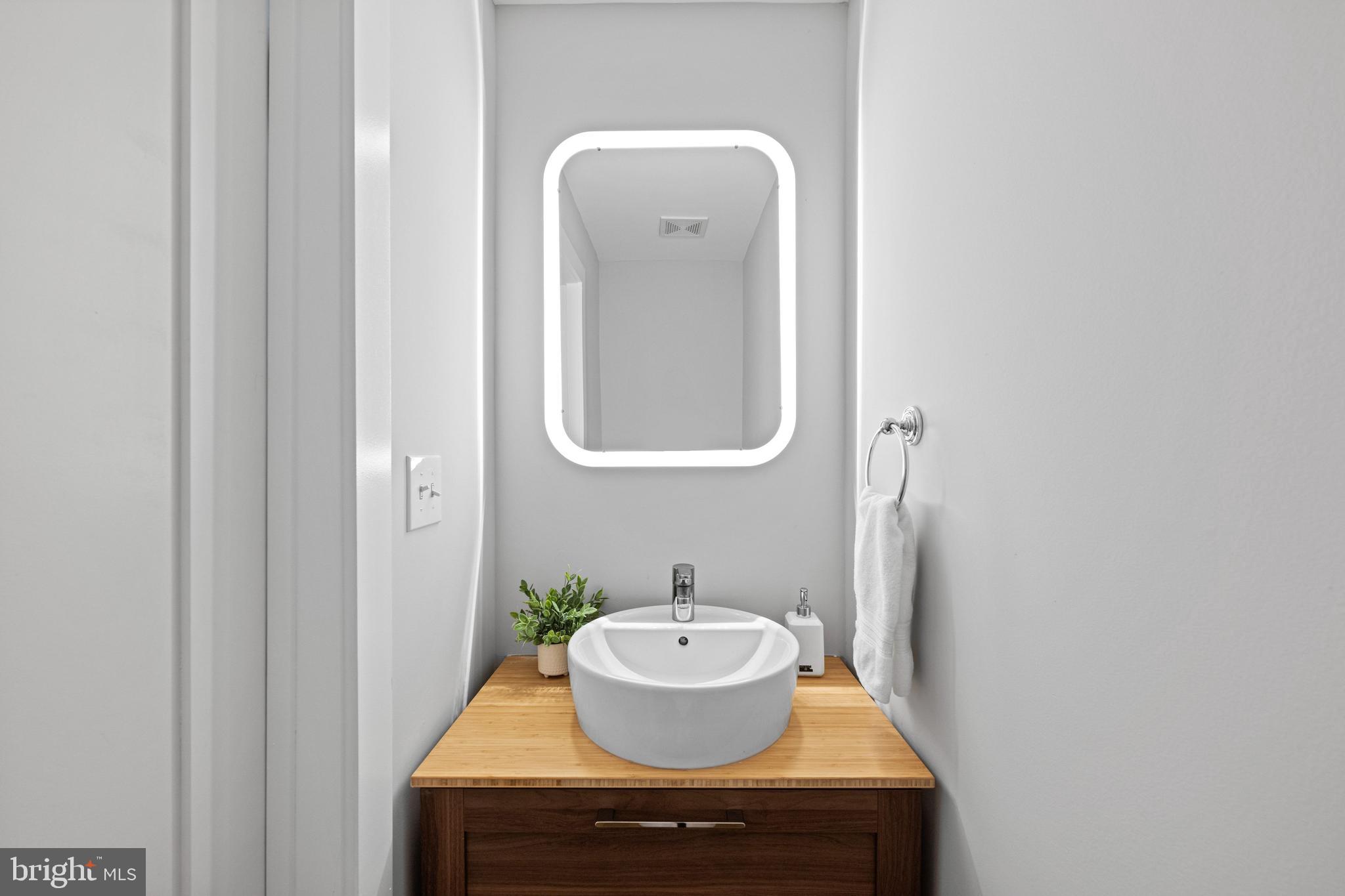 1124 4th Street Northeast Washington, DC 20002 - Photo 11 of 34 a bathroom with a sink and a mirror