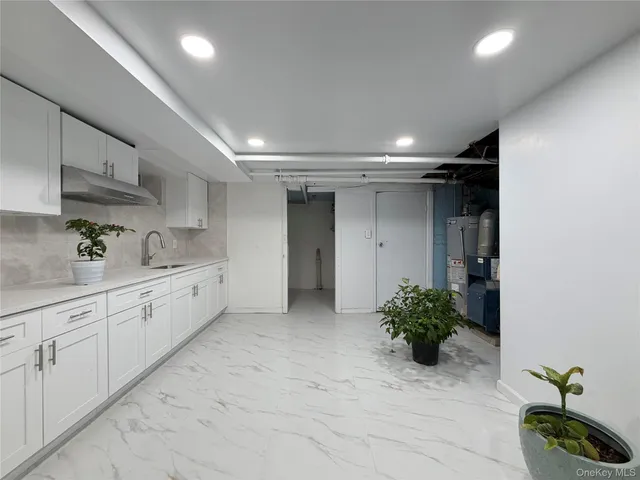 a bathroom with a sink and a potted plant