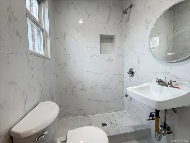 a bathroom with a sink toilet and a mirror