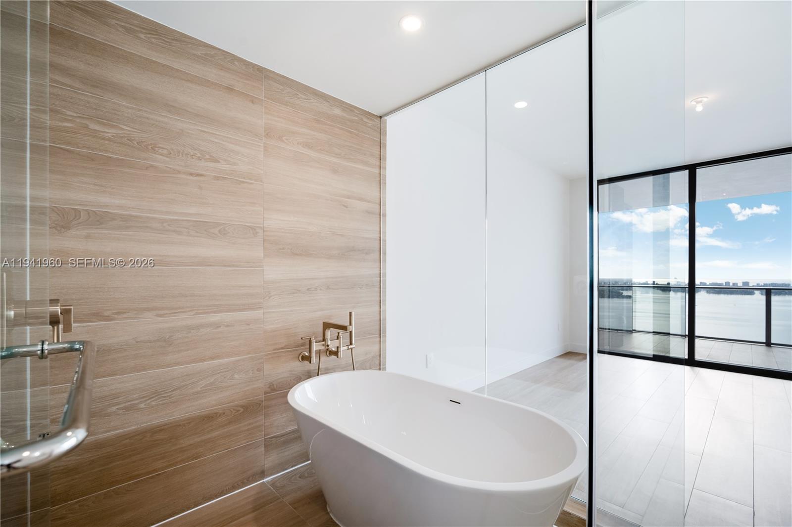 700 Northeast 24th Street, Unit 4203 Miami, FL 33137 - Photo 21 of 51 a white bath tub sitting next to a white sink