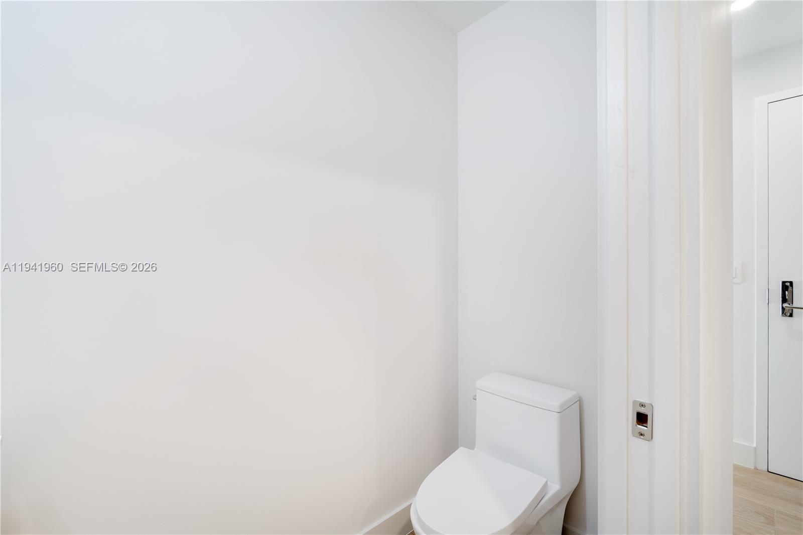 700 Northeast 24th Street, Unit 4203 Miami, FL 33137 - Photo 28 of 51 a white toilet sitting next to a white wall