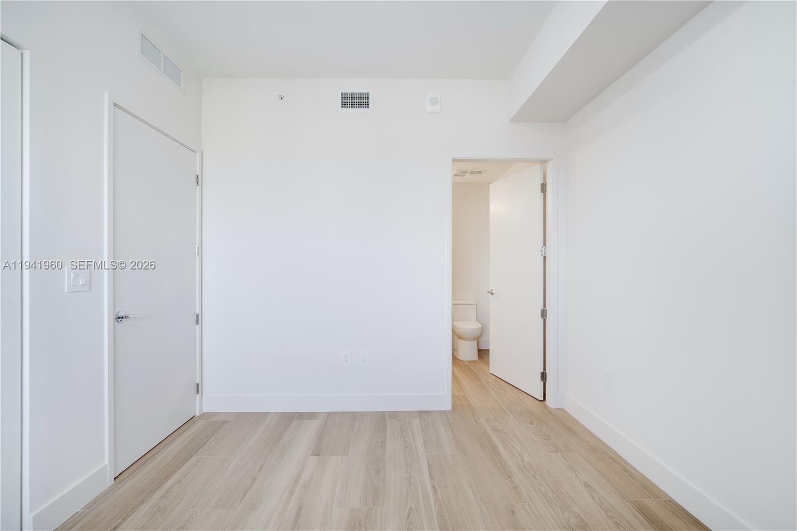 700 Northeast 24th Street, Unit 4203 Miami, FL 33137 - Photo 32 of 51 an empty room with wooden floor and closet