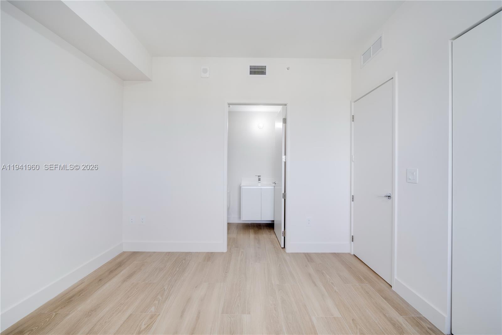 700 Northeast 24th Street, Unit 4203 Miami, FL 33137 - Photo 35 of 51 a view of an empty room with wooden floor and a window